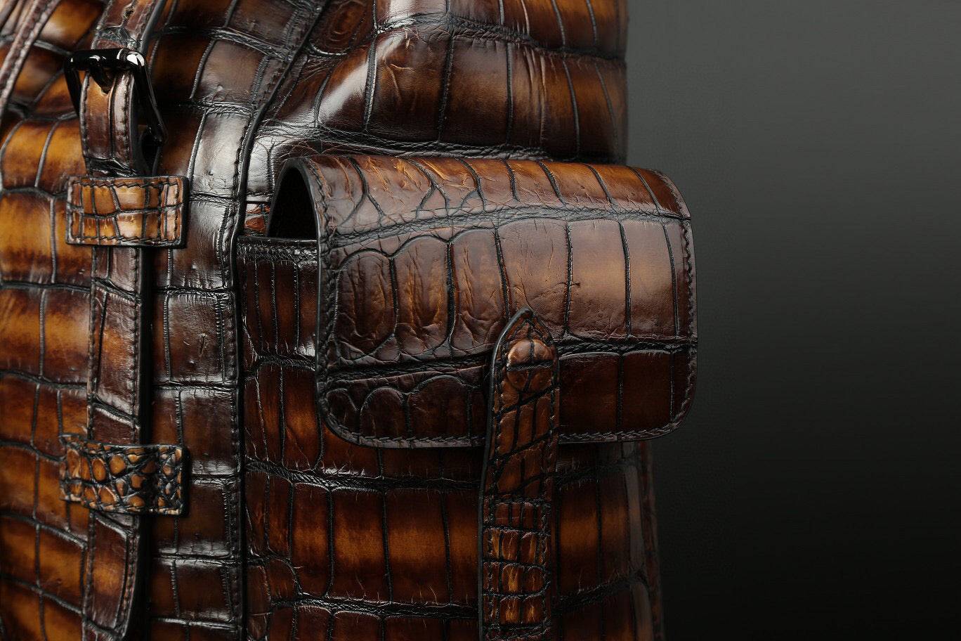 Genuine crocodile leather handbag by Rossie Viren with sturdy straps and sleek design, showcasing luxurious craftsmanship.