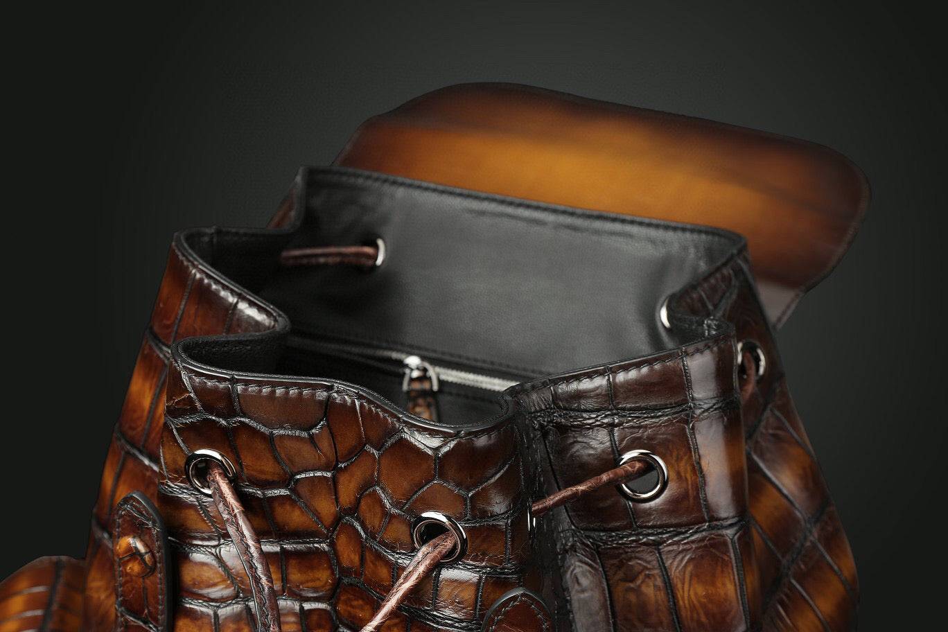 Genuine crocodile leather handbag by Rossie Viren featuring a sleek, textured design with adjustable straps and silver hardware.