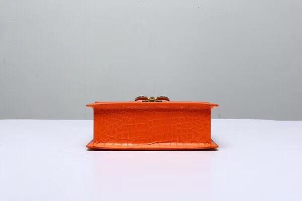 Genuine Siamese crocodile leather top handle and shoulder bag in vibrant orange, designed by Rossie Viren.