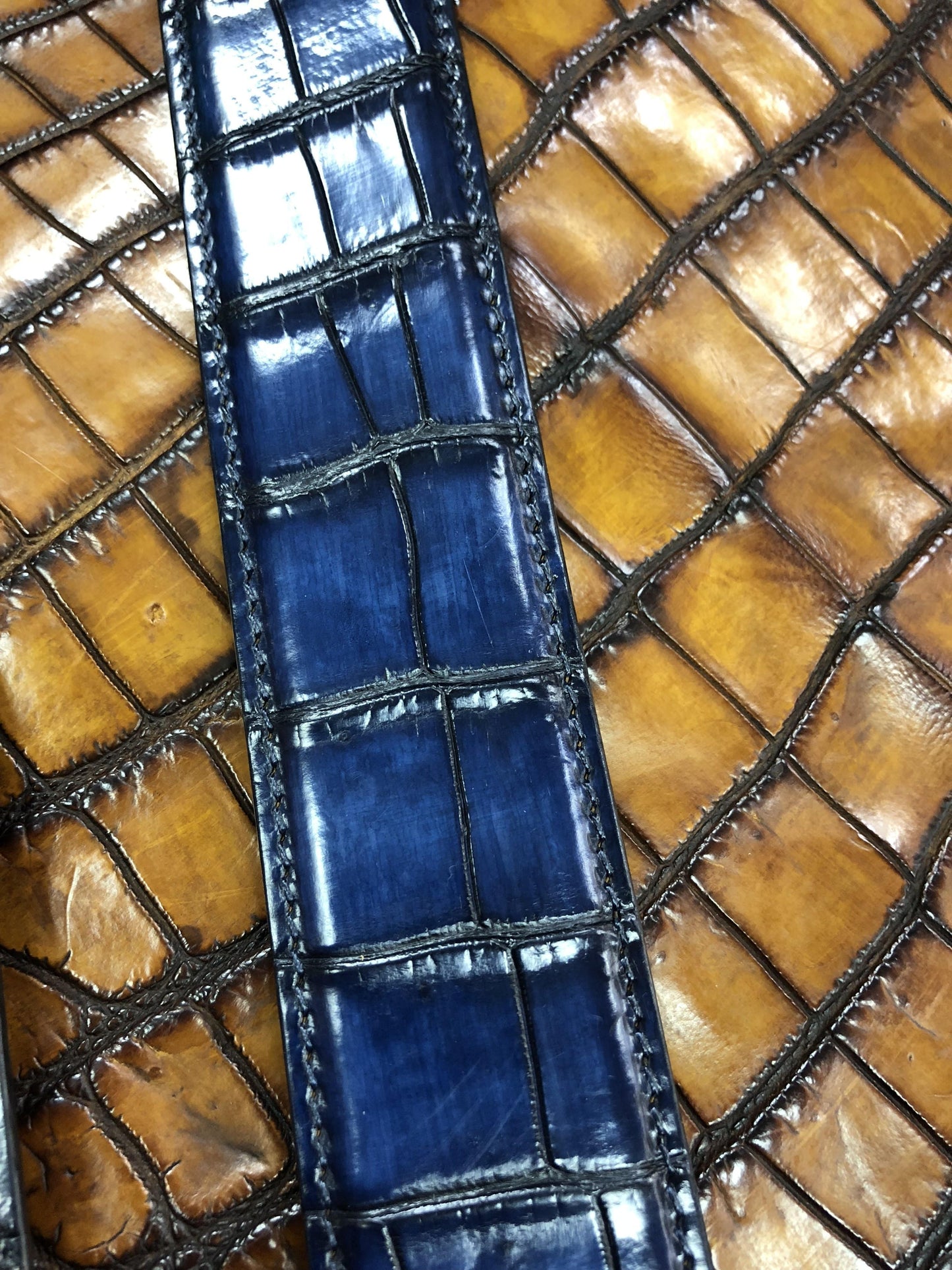 Hand-painted genuine crocodile leather belt by Rossie Viren, showcasing intricate craftsmanship and luxurious texture.