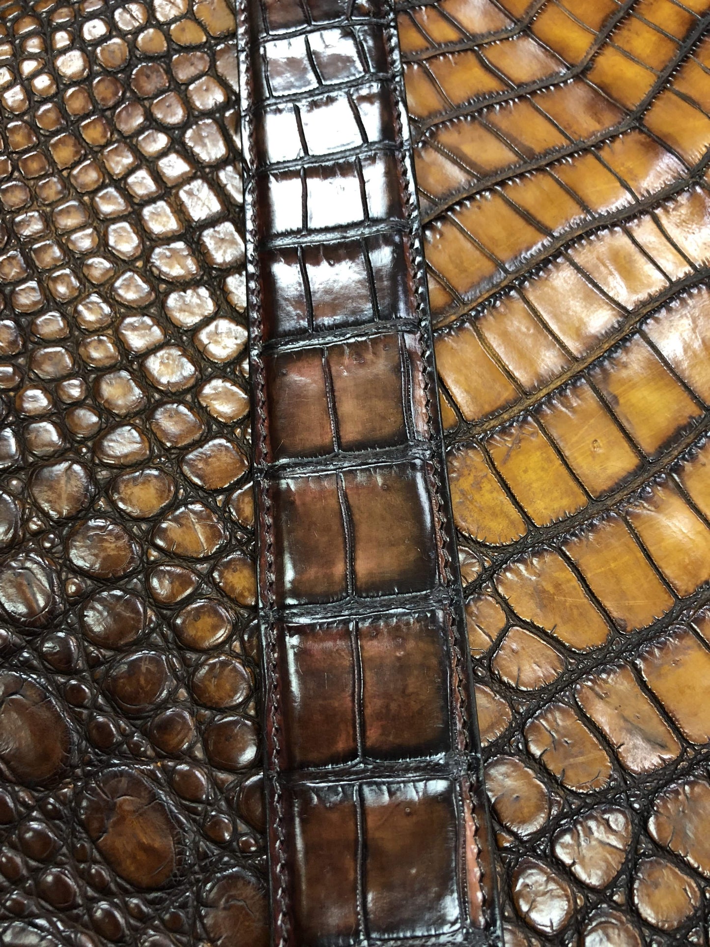 Hand-painted genuine crocodile leather belt in vintage mauve by Rossie Viren, showcasing detailed craftsmanship and luxurious texture.