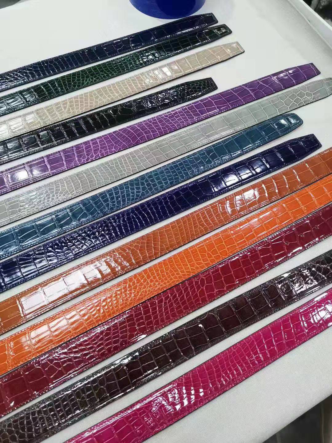 High shiny Nile crocodile skin leather belt by Rossie Viren, featuring a glossy finish and intricate crocodile pattern.