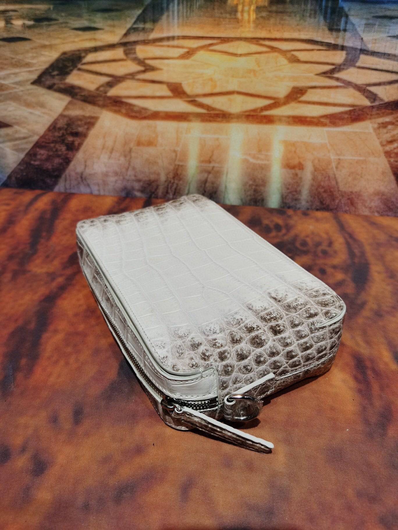 Rossie Viren Himalaya White genuine crocodile leather backpack with shoulder, chest, and crossbody styles, featuring a sleek clutch design.