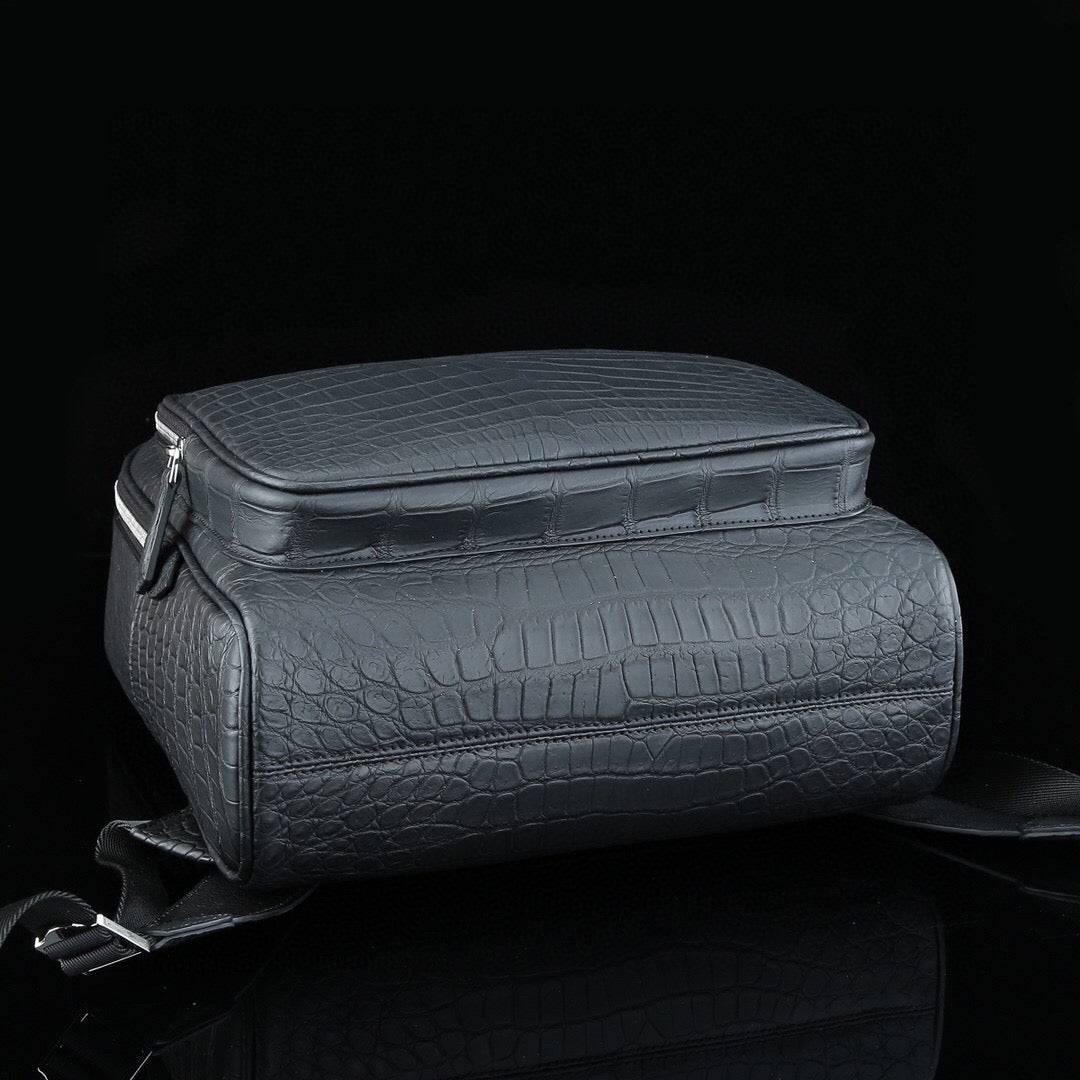 Large matte black crocodile leather backpack by Rossie Viren, featuring a textured crocodile pattern and sturdy shoulder straps.