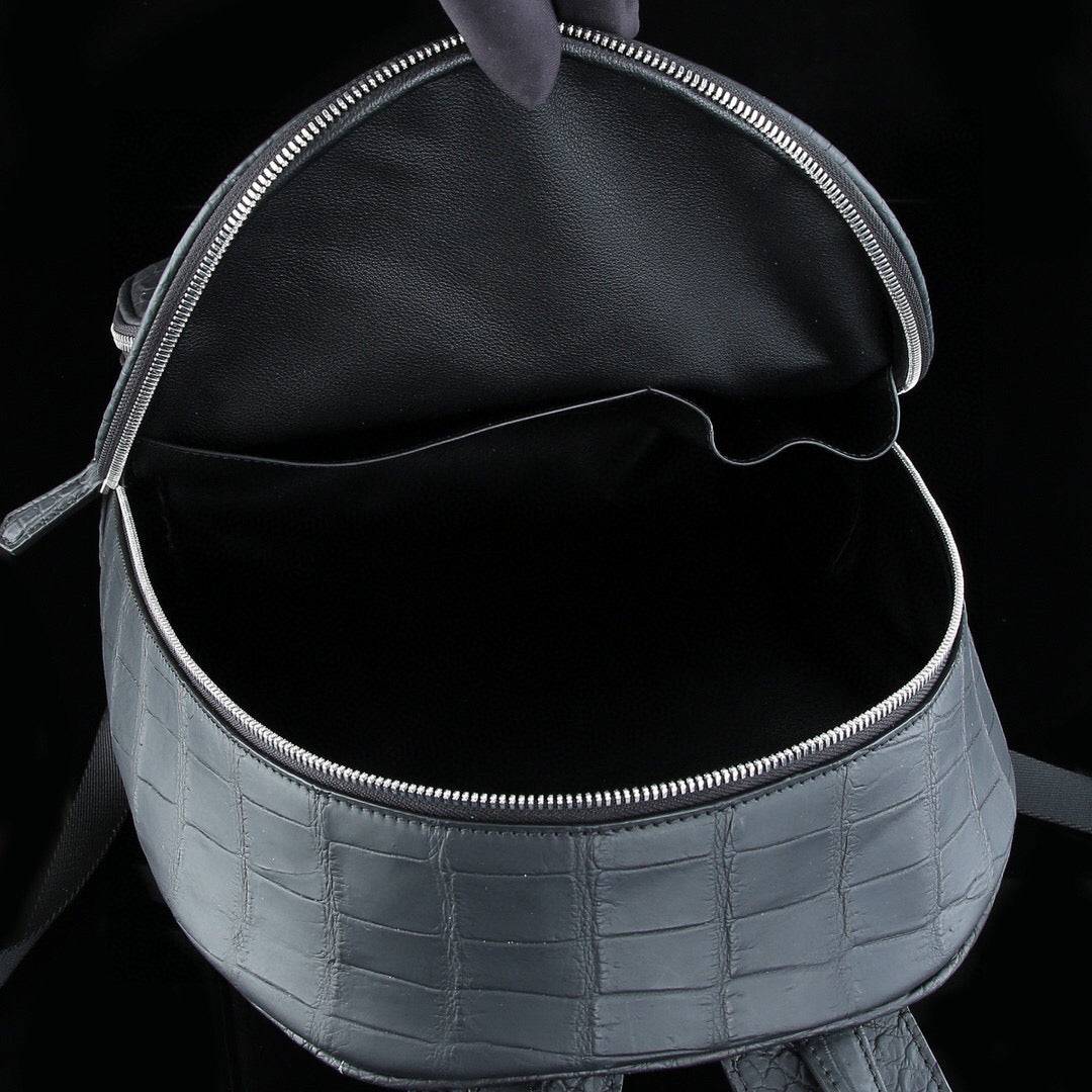 Large matte black crocodile leather backpack by Rossie Viren, featuring textured crocodile skin and sturdy leather straps.
