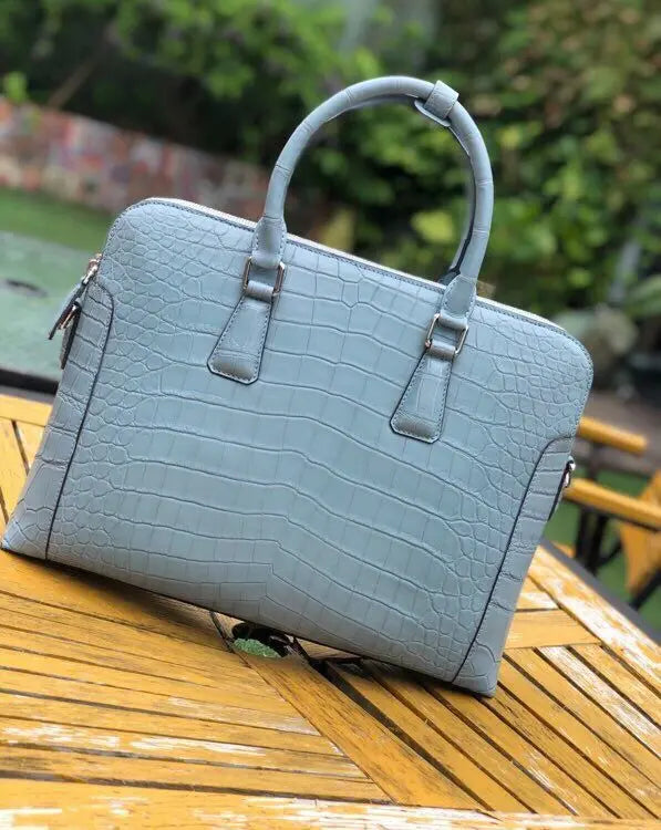 Men's crocodile leather laptop bag and briefcase by Rossie Viren, featuring a sophisticated handbag design with sturdy handles.