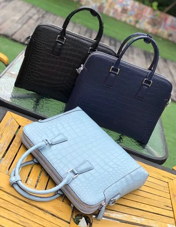 Men's crocodile leather briefcase handbag by Rossie Viren, with sturdy handles and professional design for carrying laptops.