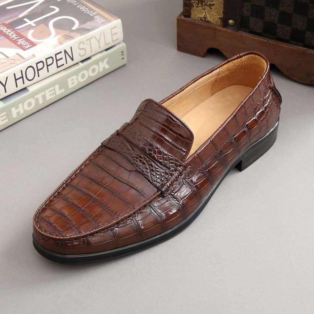 Men's crocodile leather slip-on loafers by Rossie Viren, showcasing the textured crocodile pattern and sleek loafer design.