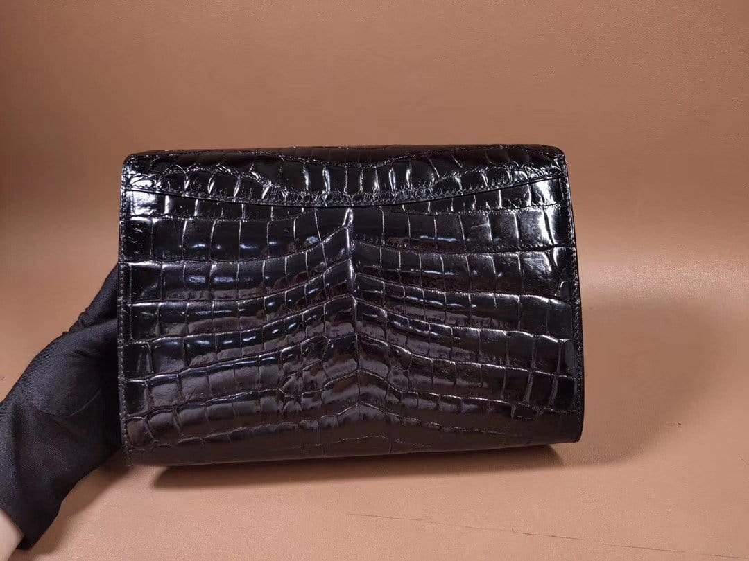 Men's black genuine crocodile leather clutch bag by Rossie Viren with high gloss finish and beaded details.