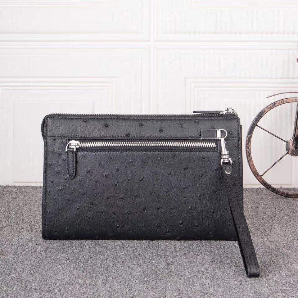 Mens genuine ostrich leather clutch bag with zipper, card wallet, and wrist handle by Rossie Viren.