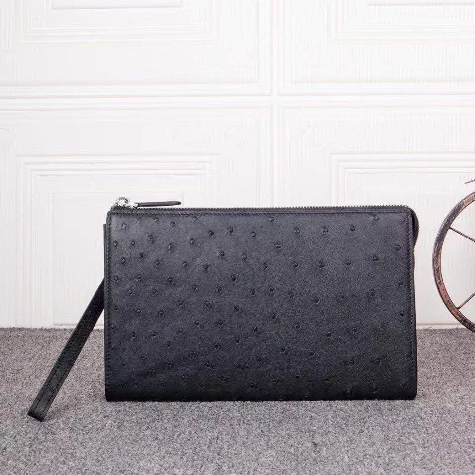 Mens genuine ostrich leather clutch bag with zipper, card wallet, and wrist handle by Rossie Viren.
