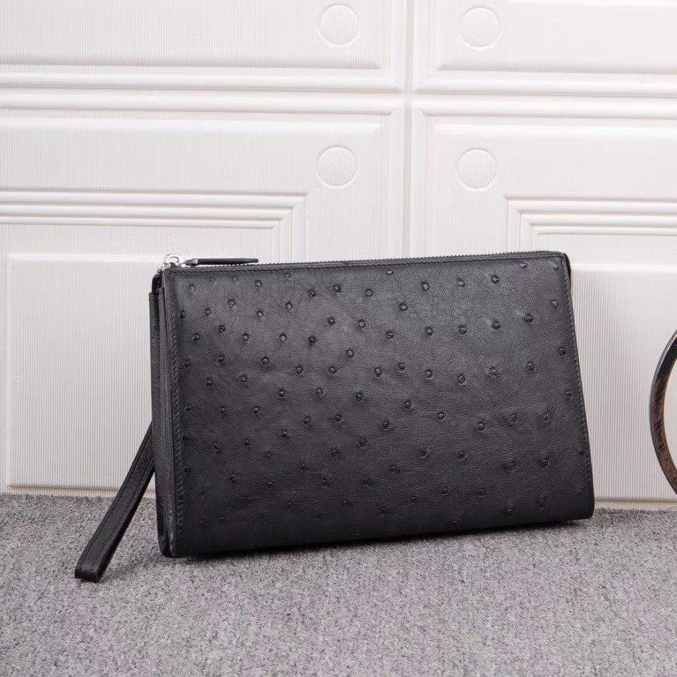 Mens genuine ostrich leather clutch bag with zipper, card wallet, and wrist handle by Rossie Viren.