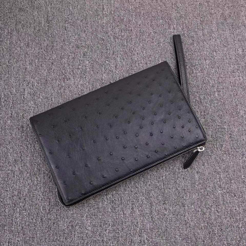 Mens genuine ostrich leather clutch bag with zipper, card wallet, and wrist handle by Rossie Viren.