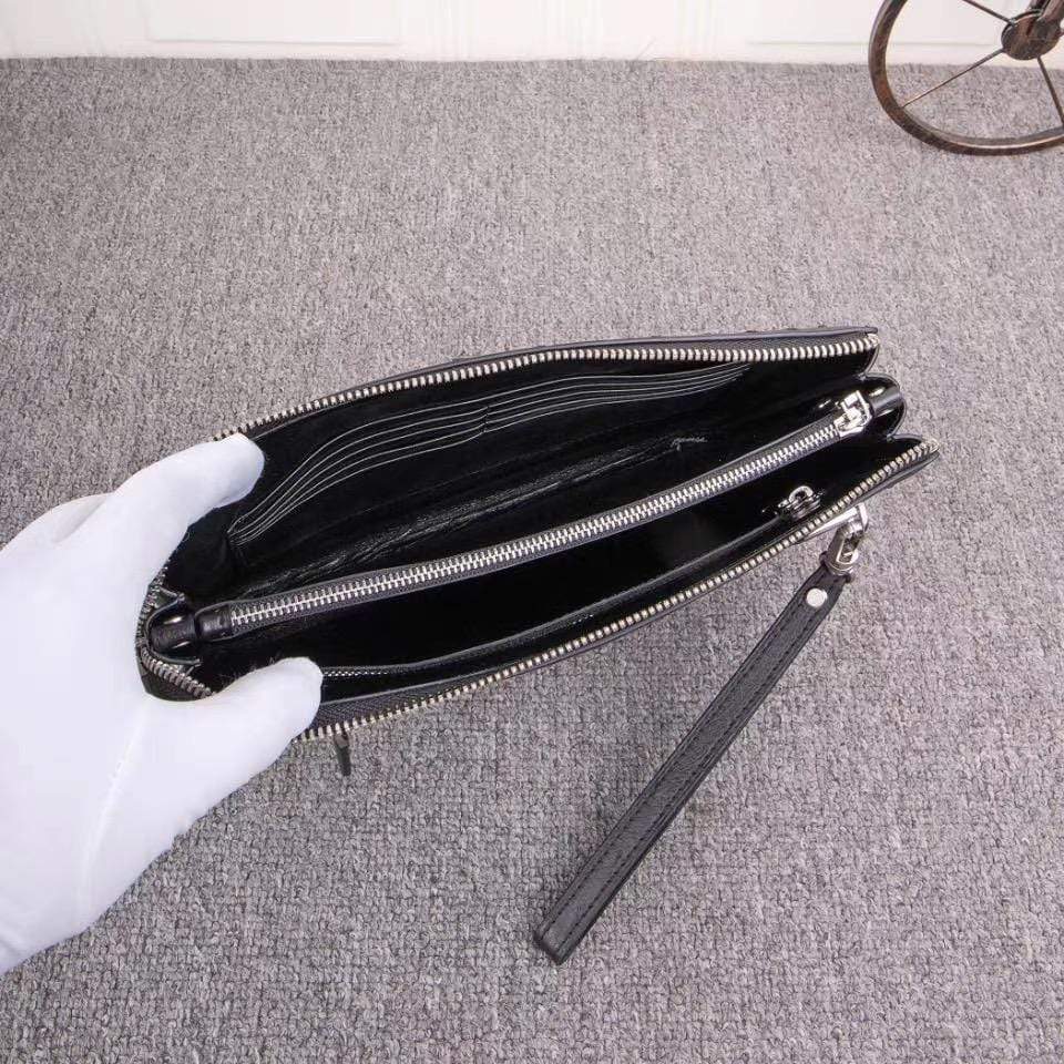 Mens genuine ostrich leather clutch bag with zipper, wrist handle, and card wallet by Rossie Viren.