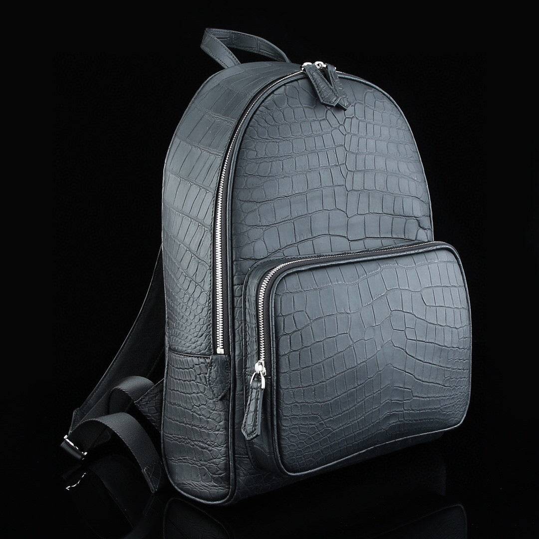 Large matte black crocodile leather backpack by Rossie Viren, featuring sturdy straps and a sleek, textured crocodile pattern.