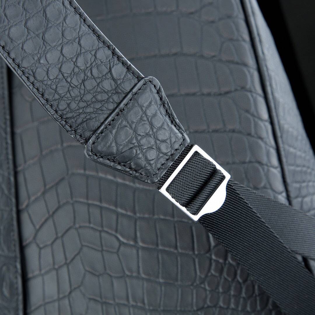 Large black Rossie Viren crocodile leather backpack with matte finish, featuring sturdy straps and textured crocodile pattern.
