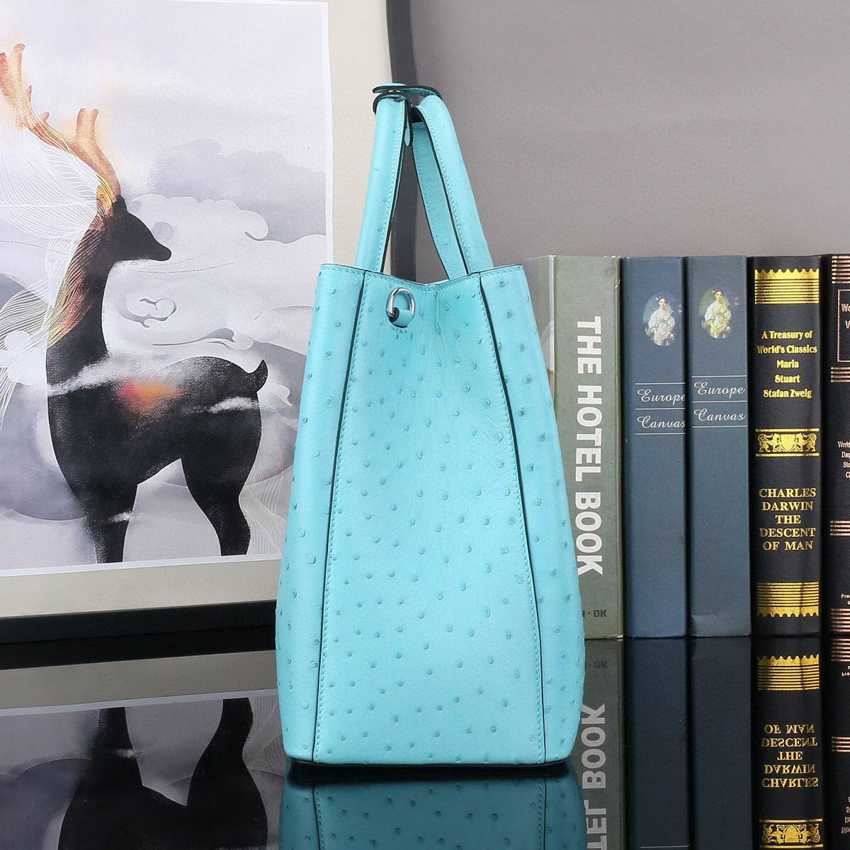 Blue ostrich leather top handle shoulder bag by Rossie Viren, 32cm handbag with elegant design and textured finish.