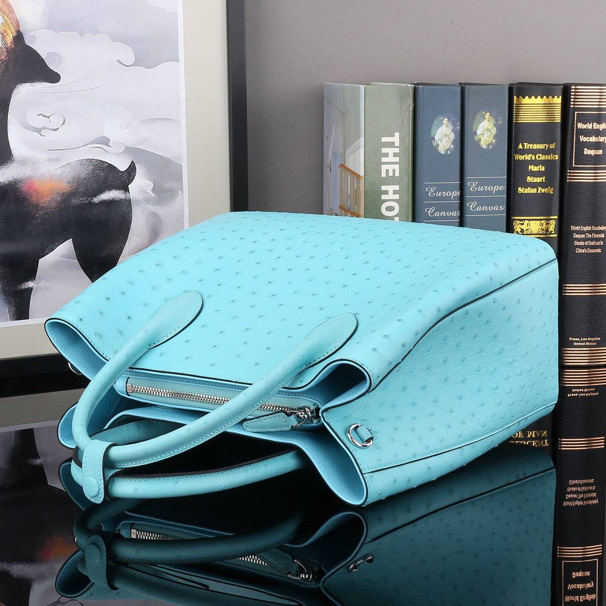 Blue ostrich leather top handle shoulder bag by Rossie Viren, 32cm handbag with elegant textured finish.