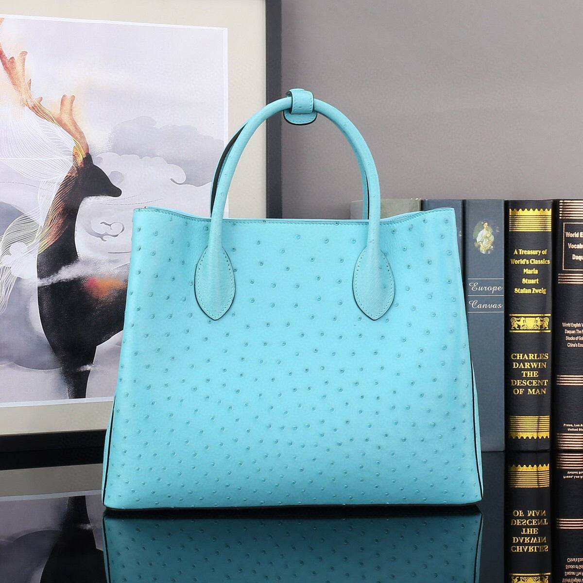 Blue ostrich leather top handle shoulder bag by Rossie Viren, 32cm handbag with elegant design and textured leather finish.
