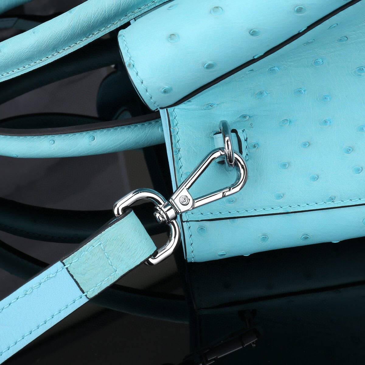 Blue ostrich leather top handle shoulder bag by Rossie Viren, 32cm handbag with elegant design and textured surface.