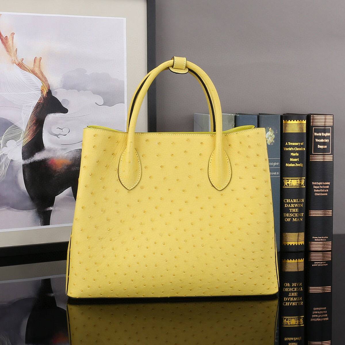 Yellow ostrich leather top handle shoulder bag by Rossie Viren, 32cm handbag with stylish design and textured leather finish.