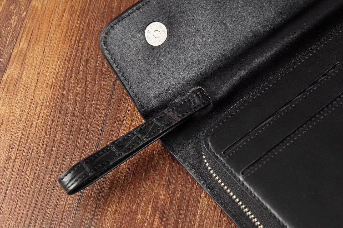 Black crocodile skin leather trifold wallet for men by Rossie Viren, showcasing a sleek, textured design and multiple card slots.