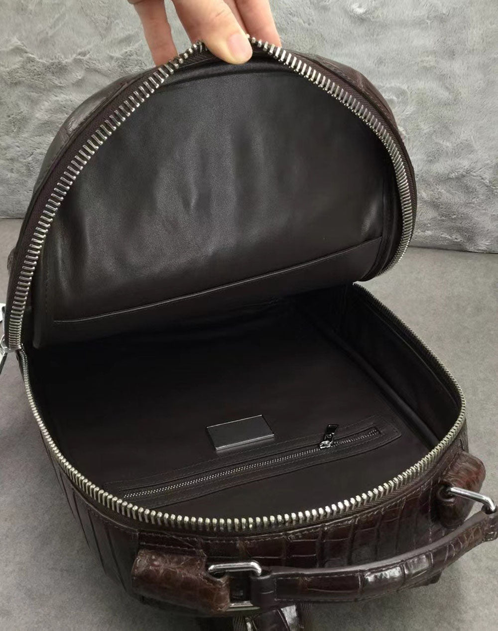 Large Rossie Viren crocodile skin leather backpack with textured crocodile pattern and sturdy straps.
