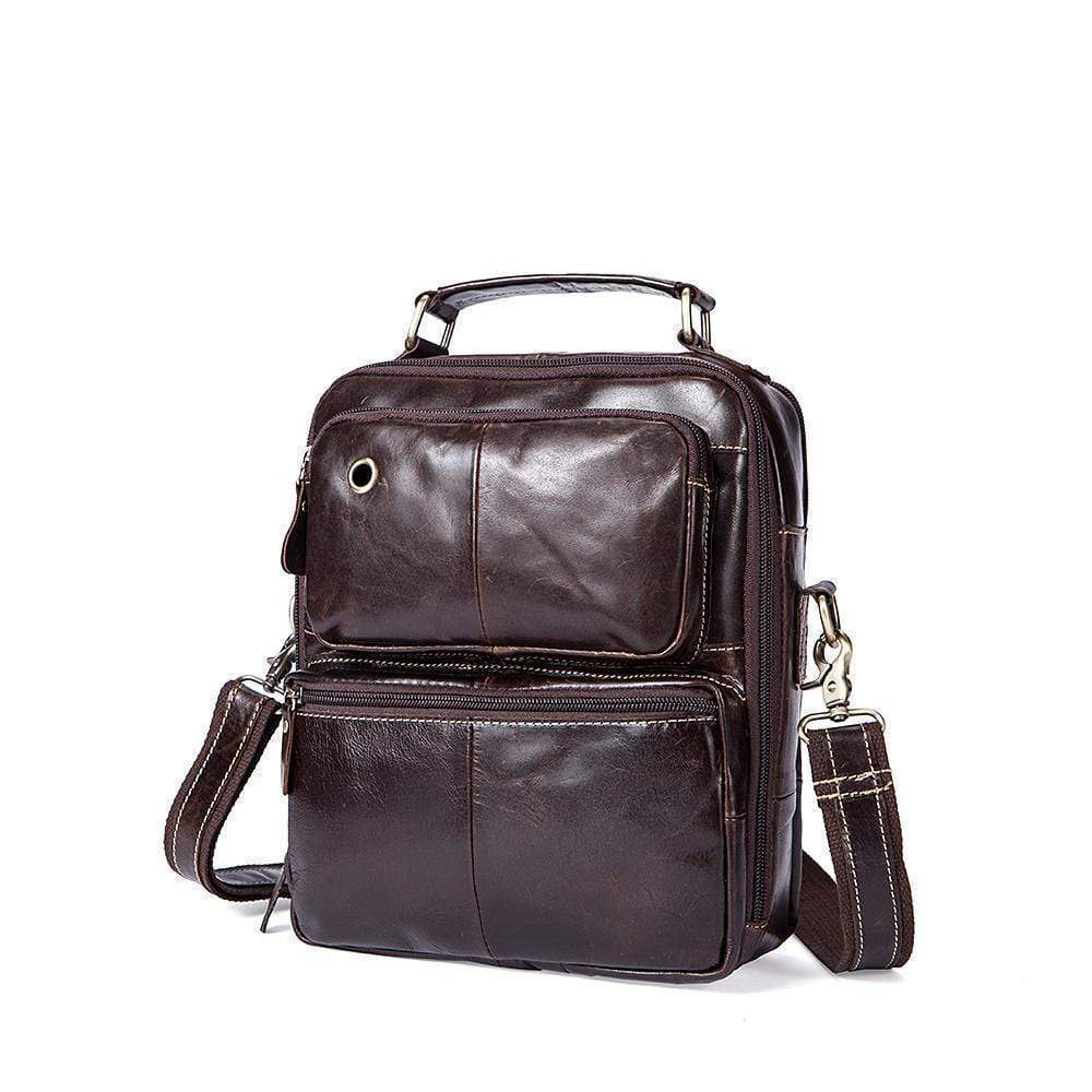 Rossie Viren vintage crossbody handbag with two front pockets, grab handle, and long shoulder strap, displayed on a plain background.
