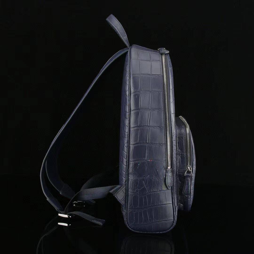 Large black crocodile leather backpack by Rossie Viren, showing side view with textured crocodile pattern and sturdy straps.