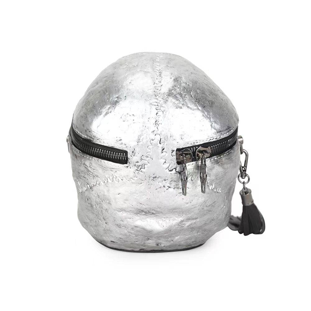 Silver 3D skull cross body handle bag by Rossie Viren with mini size, featuring a silver finish and shoulder strap detail.