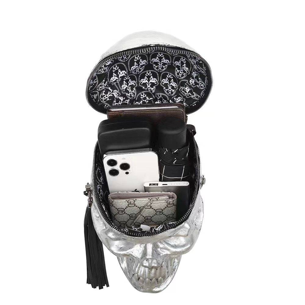 Silver 3D skull crossbody handle bag by Rossie Viren with mini size and shoulder strap, featuring a detailed skull design.