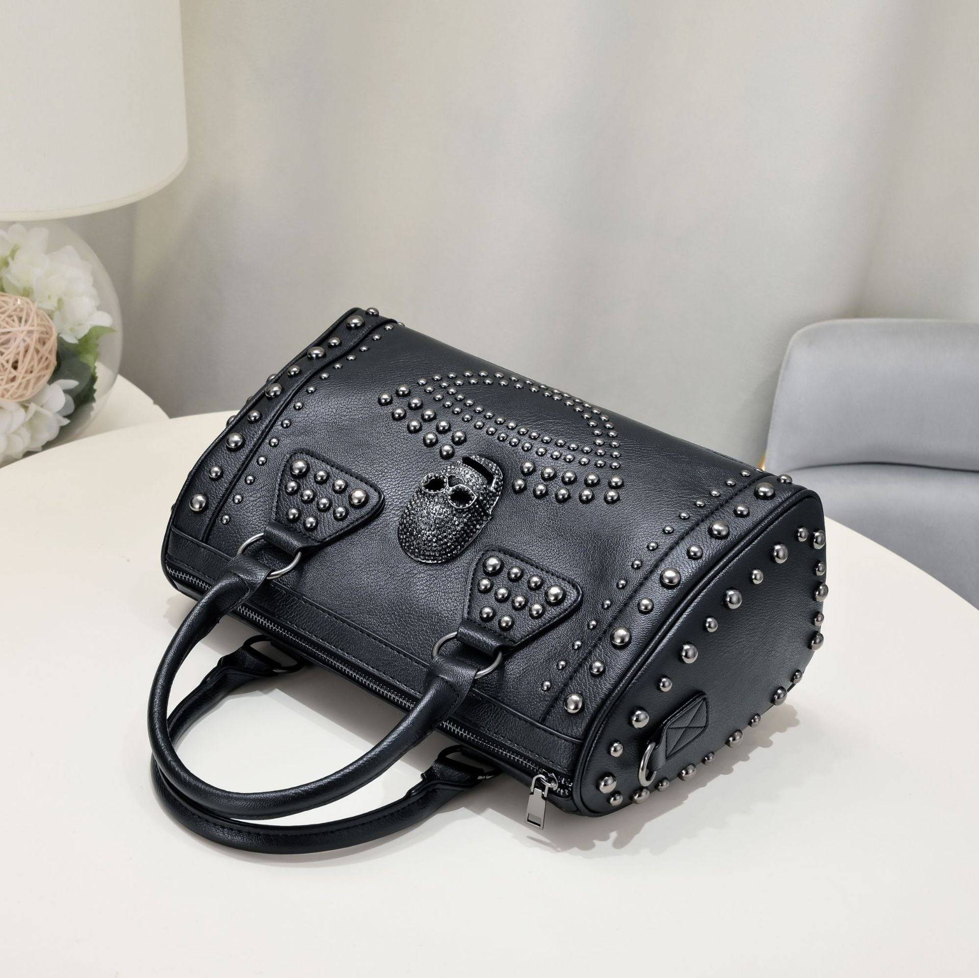 Rossie Viren 3D crystal skull shoulder bag with studded details and structured satchel design.