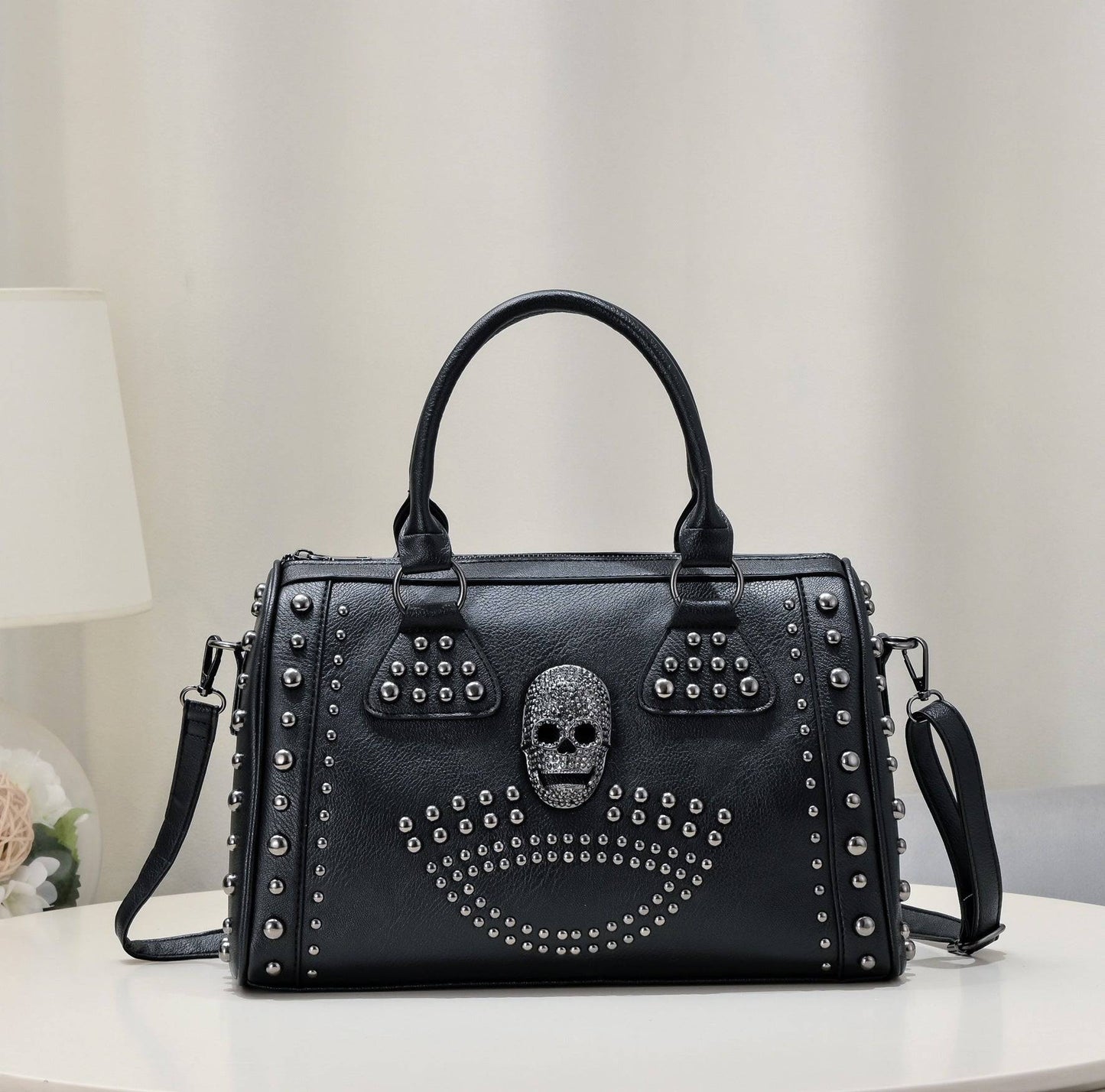 Rossie Viren 3D Crystal Skull Shoulder Bag with studded accents, featuring a detailed skull design and a sleek satchel style.