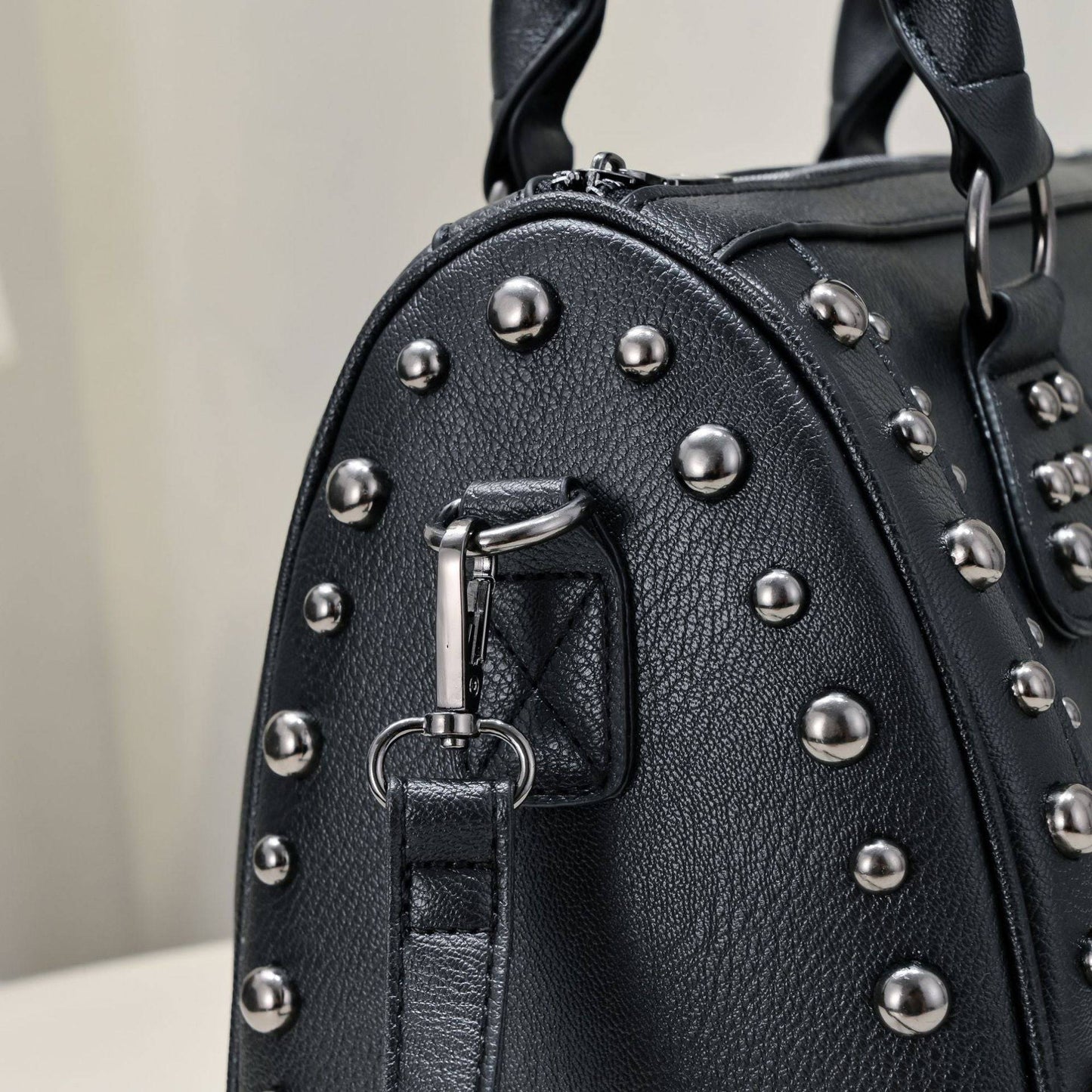 Rossie Viren 3D crystal skull shoulder bag with studded satchel design, featuring a detailed skull motif and textured embellishments.