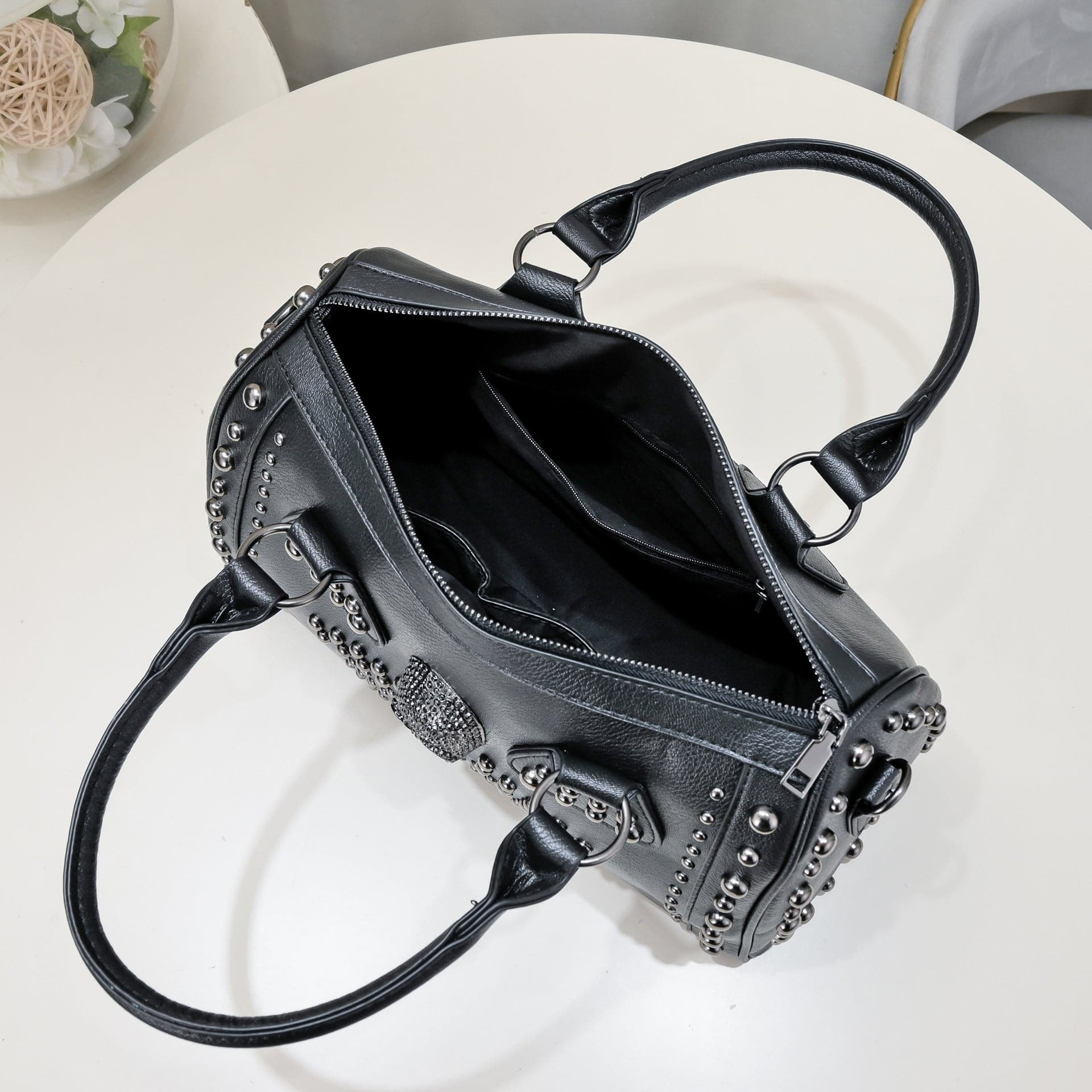 Rossie Viren 3D crystal skull shoulder bag with studded satchel design, featuring a detailed skull embellishment and textured leather accents.