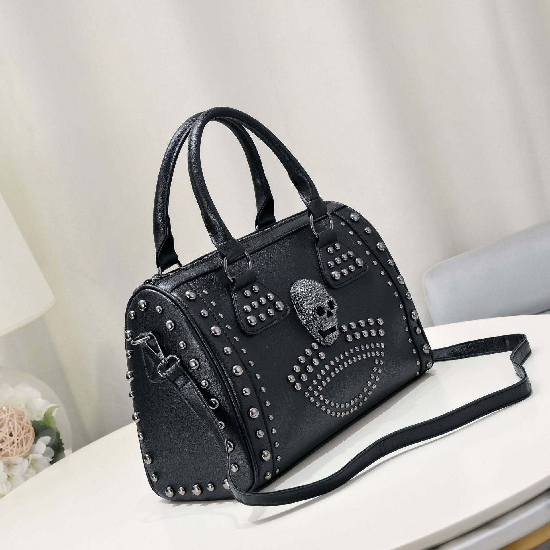 Rossie Viren 3D crystal skull shoulder bag with studded satchel details, featuring a striking skull design on the front.