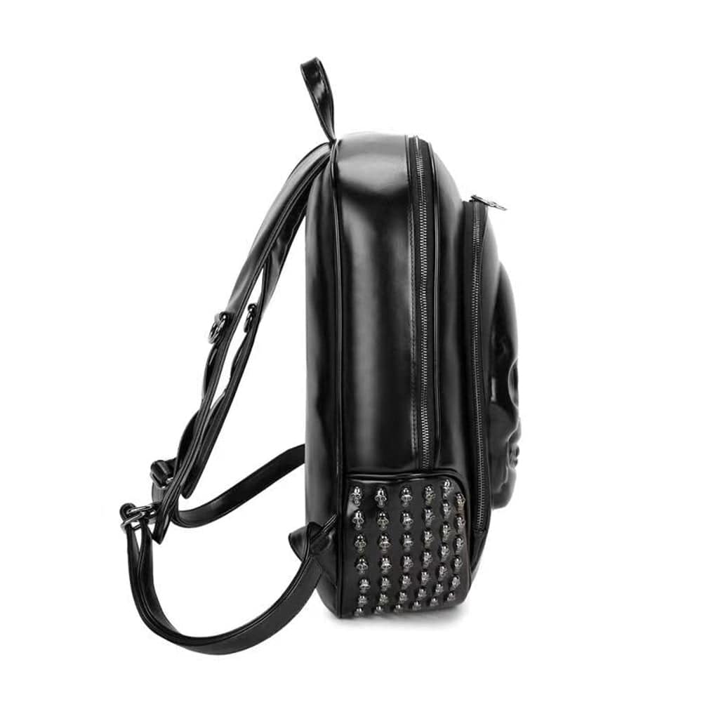 Black 3D studded smiling skull backpack by Rossie Viren, featuring edgy design and adjustable straps.