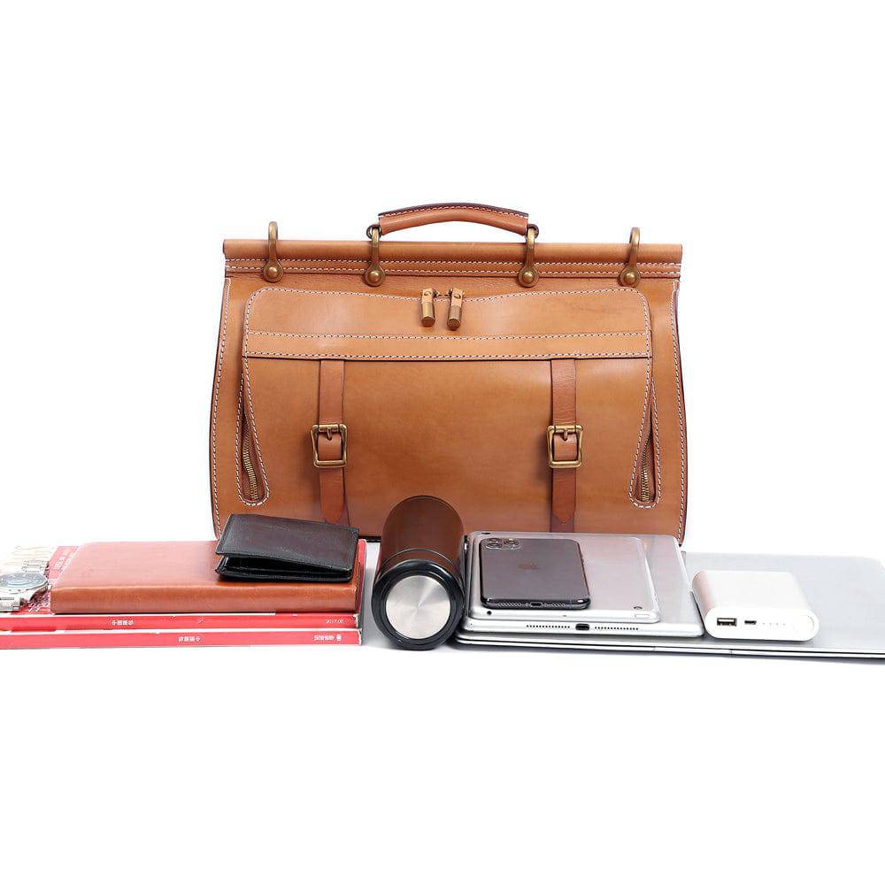 Unisex vintage genuine vegetable-tanned leather medium weekender duffle bag by Rossie Viren with luggage sleeve for travel and gym use.