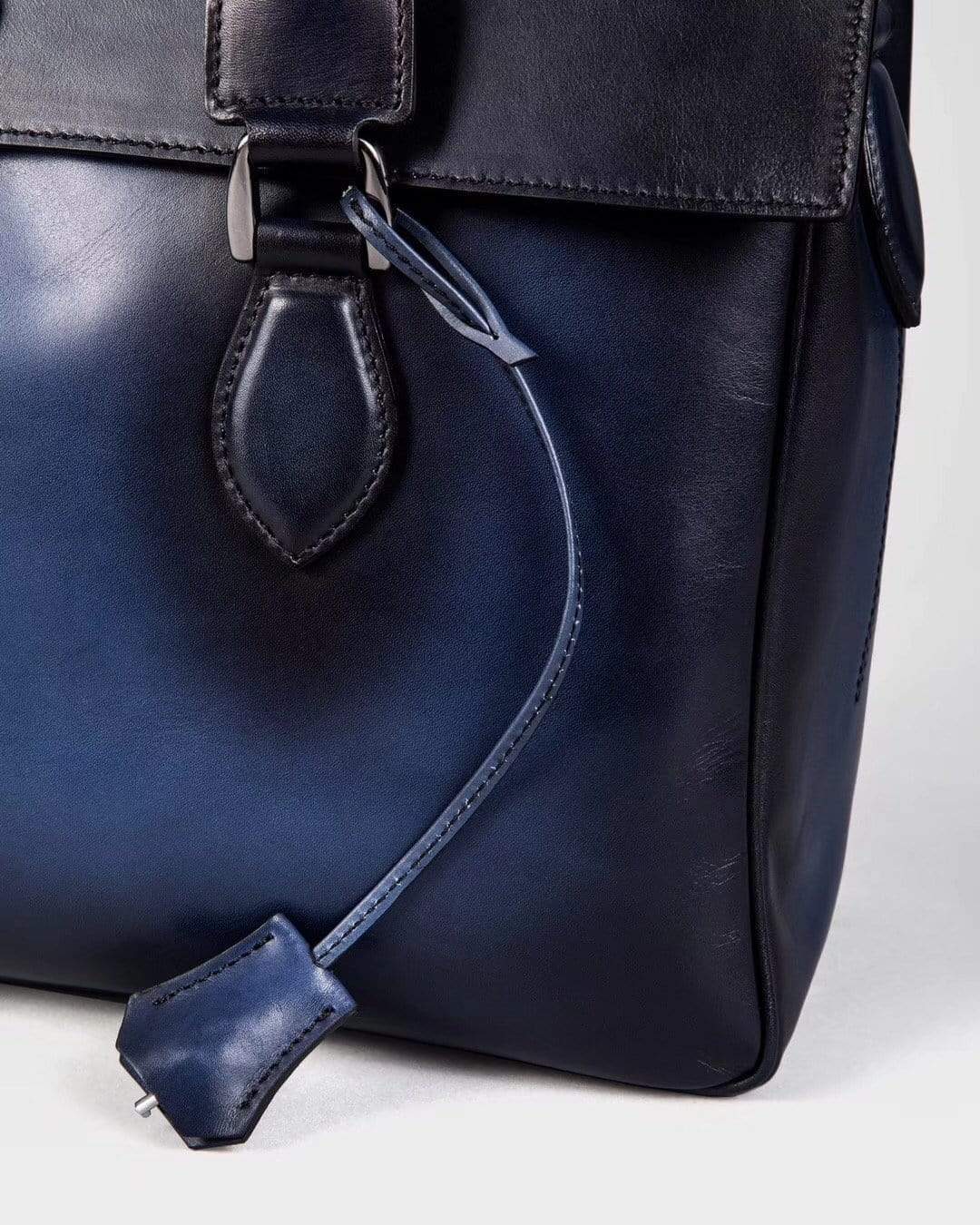 Vintage large smooth blue cowhide leather foldover briefcase handbag by Rossie Viren, showing the sleek, structured design with top handle.