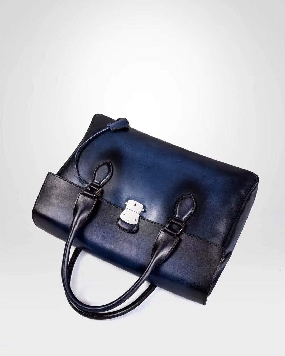 Blue vintage large cowhide leather foldover briefcase by Rossie Viren, showing smooth textured surface and classic design.