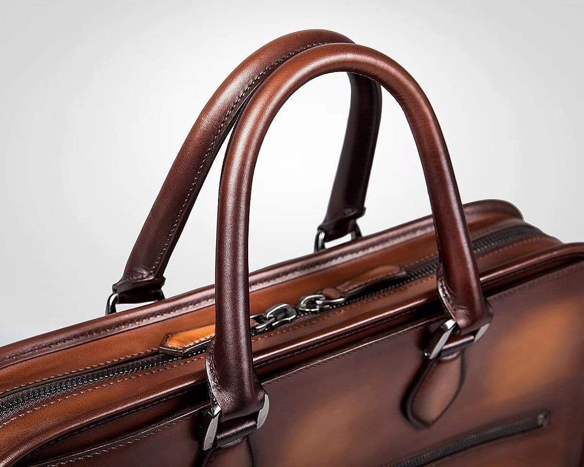 Vintage smooth cowhide leather handbag by Rossie Viren, stylish messenger bag with classic craftsmanship and durable design.