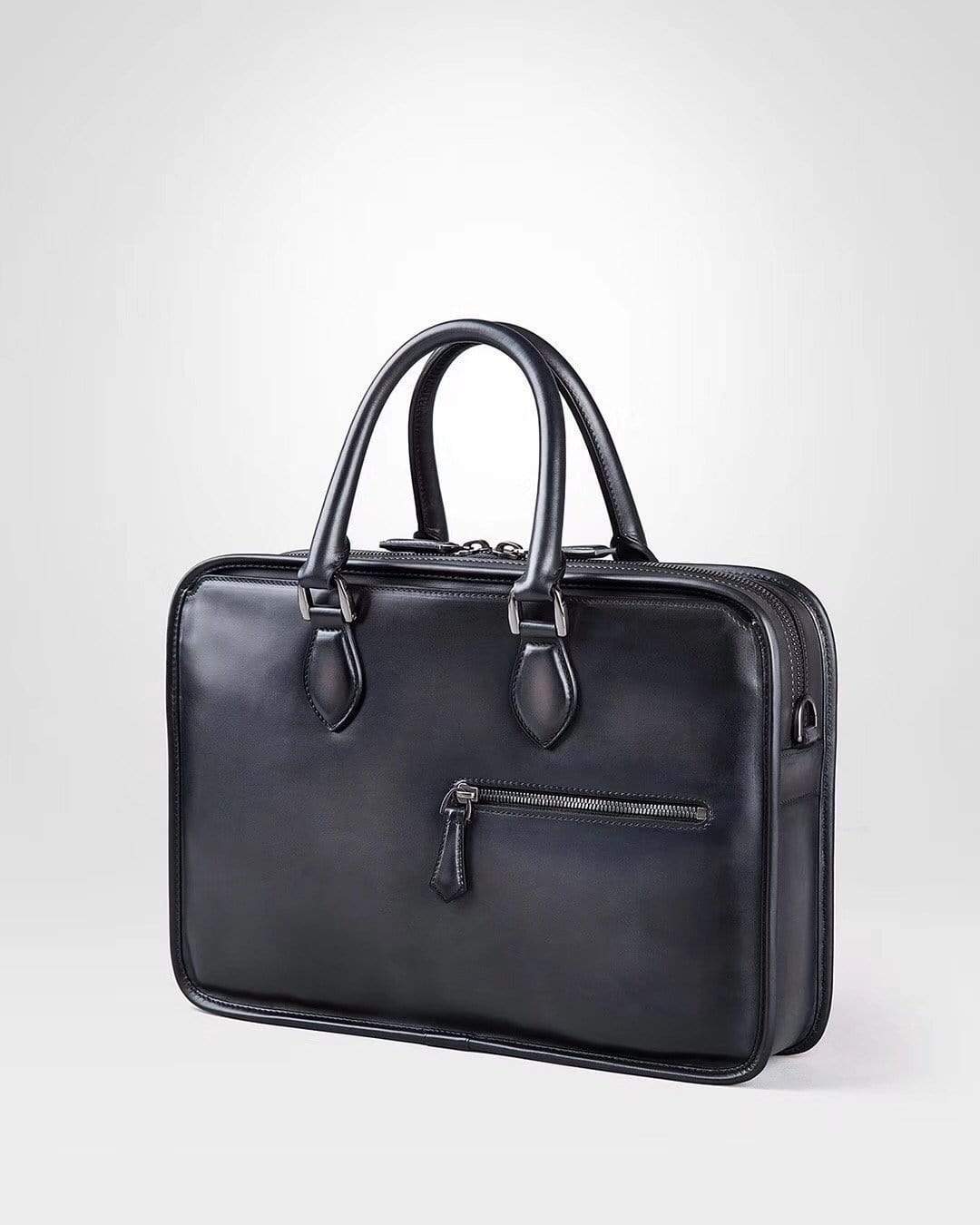 Vintage smooth cowhide leather Rossie Viren handbag with a sleek, compact design and sturdy handles.