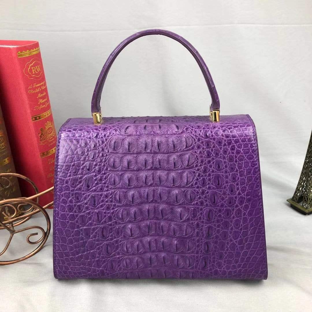 Women’s purple crocodile leather handbag with top handle by Rossie Viren, showcasing elegant textured crocodile pattern.