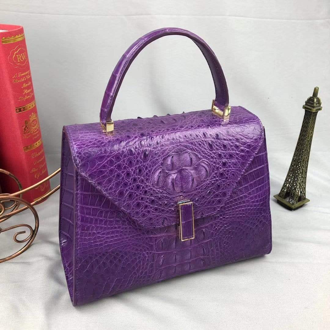 Purple crocodile leather top handle handbag for women by Rossie Viren, showcasing elegant textured leather and structured design.