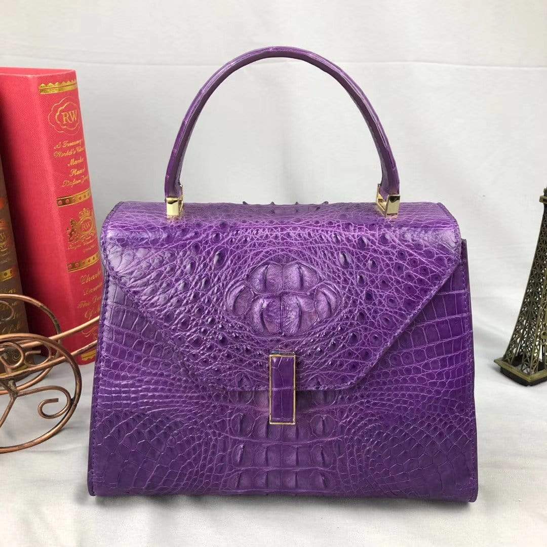 Purple women’s crocodile leather top handle handbag by Rossie Viren, featuring a sophisticated design and top handle for versatile style.