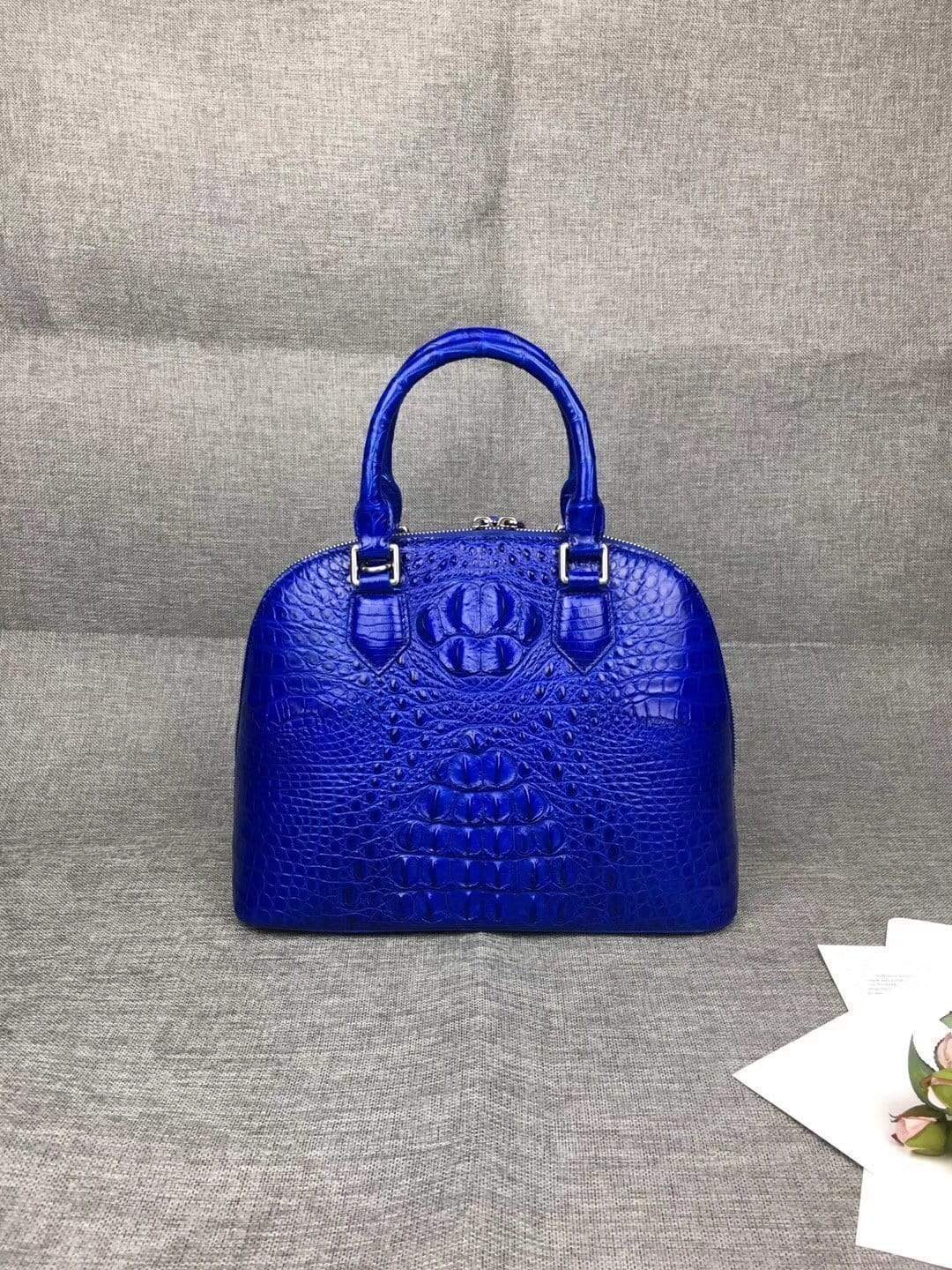 Women’s genuine crocodile leather tote bag with double handles and trapezoid shape, designed by Rossie Viren.