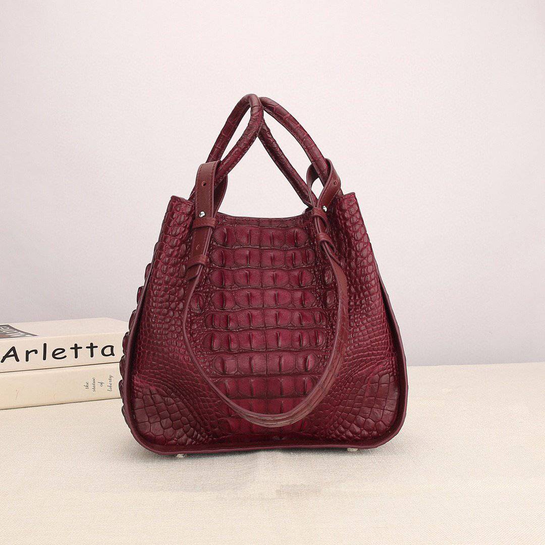 Women's genuine crocodile leather handbag with top handle and slouchy shoulder strap by Rossie Viren, showcasing luxurious texture.