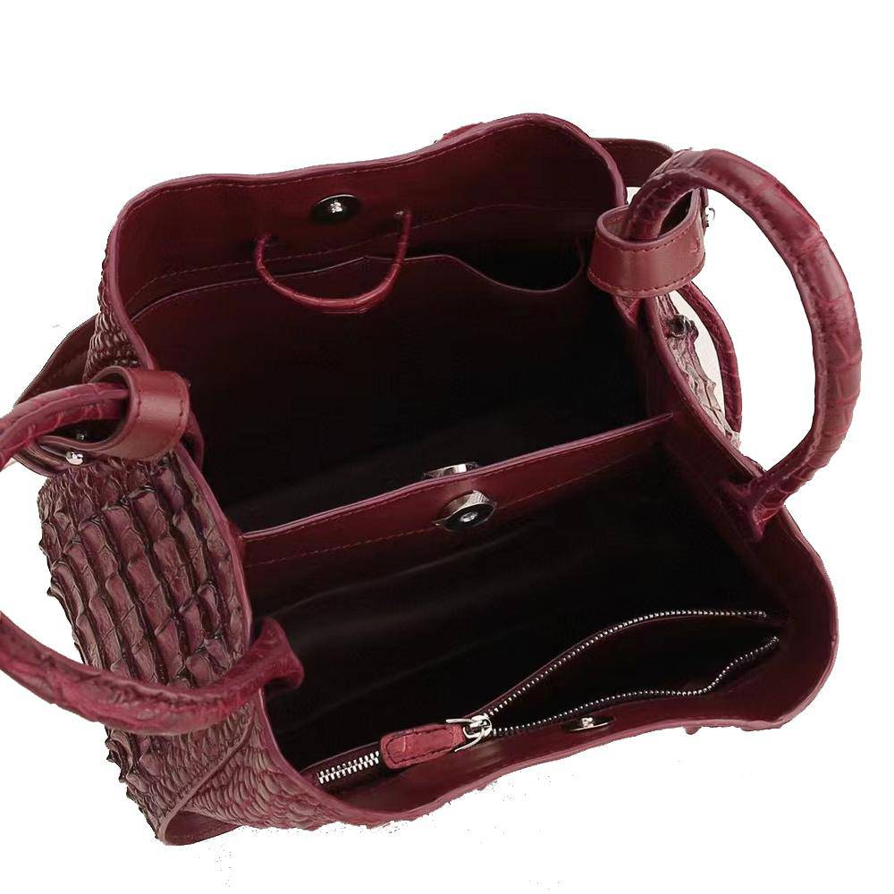 Women’s genuine crocodile leather handbag by Rossie Viren featuring a top handle and slouchy shoulder bag style.