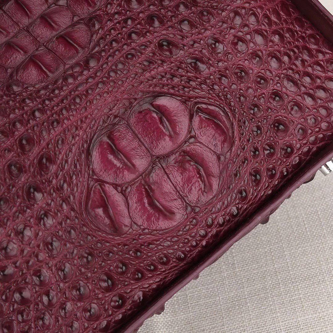 Women’s genuine crocodile leather handbag by Rossie Viren with top handle and slouchy shoulder bag design.