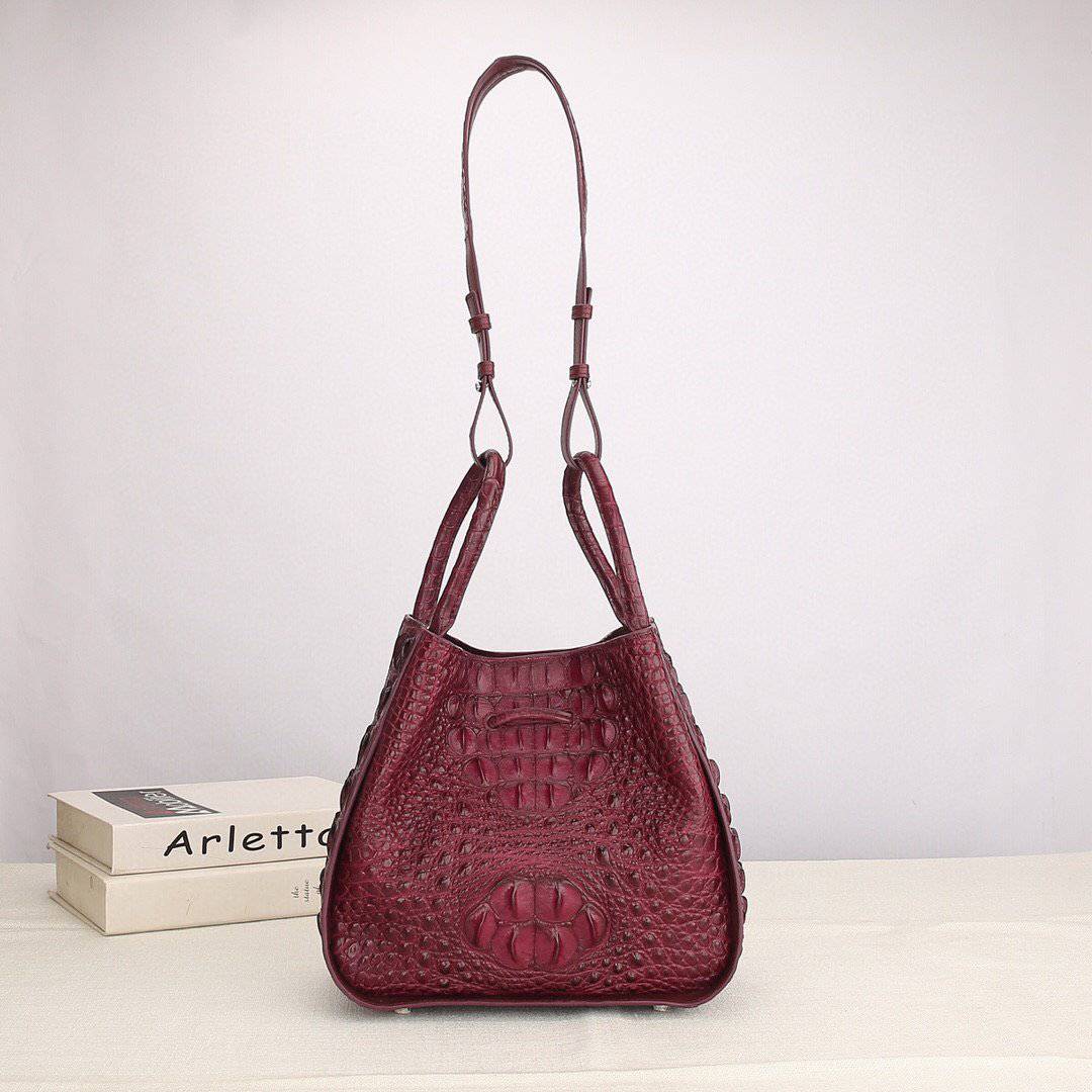 Women's Rossie Viren crocodile leather handbag with top handle and slouchy shoulder strap, featuring a sleek, textured design.